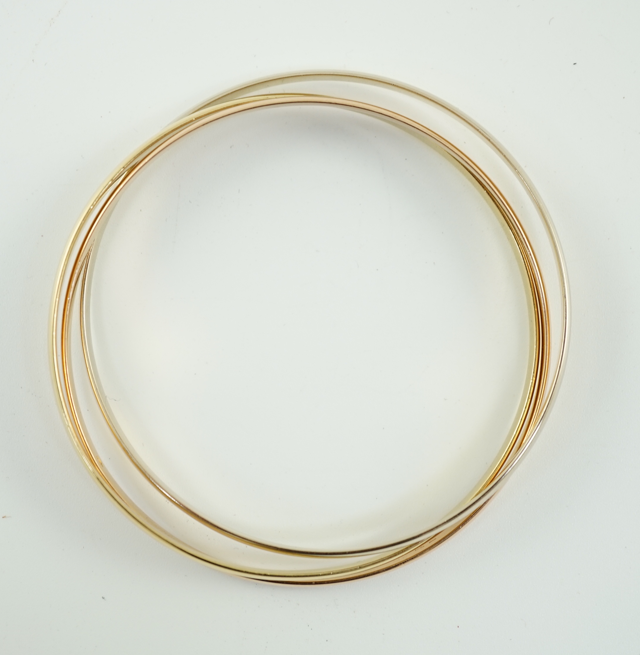 A modern three colour 18ct gold Cartier Russian triple bangle